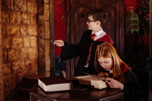 A Girl in a Harry Potter Costume Reading a Book
