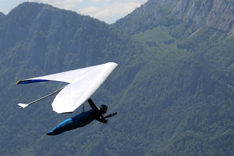 Hang Glider Flying Against A Mountain