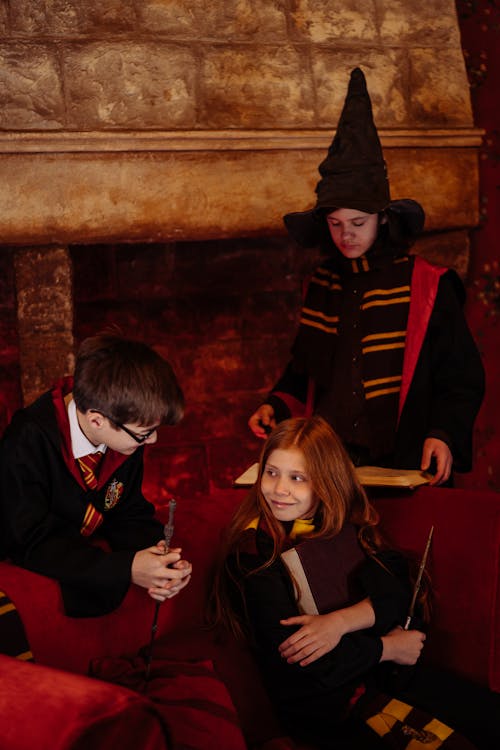 Students Sitting in a Harry Potter Black Robes Holding a Magic Wands and Spell Book