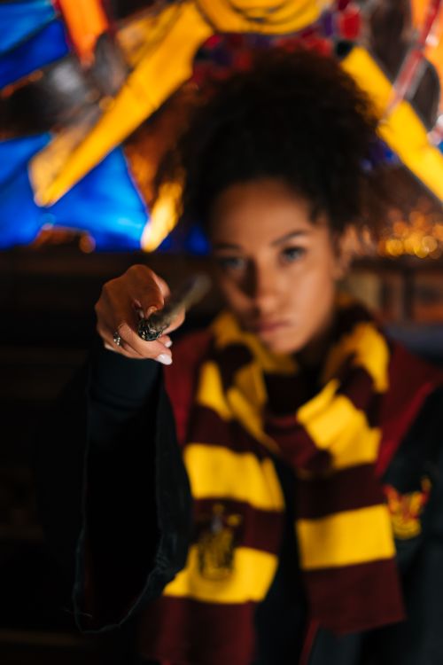 Free A wizard in colorful costume casting a spell with a wand. Stock Photo