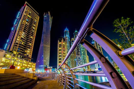 Stunning low-angle view of Dubai Marina skyline illuminated at night with modern architecture.