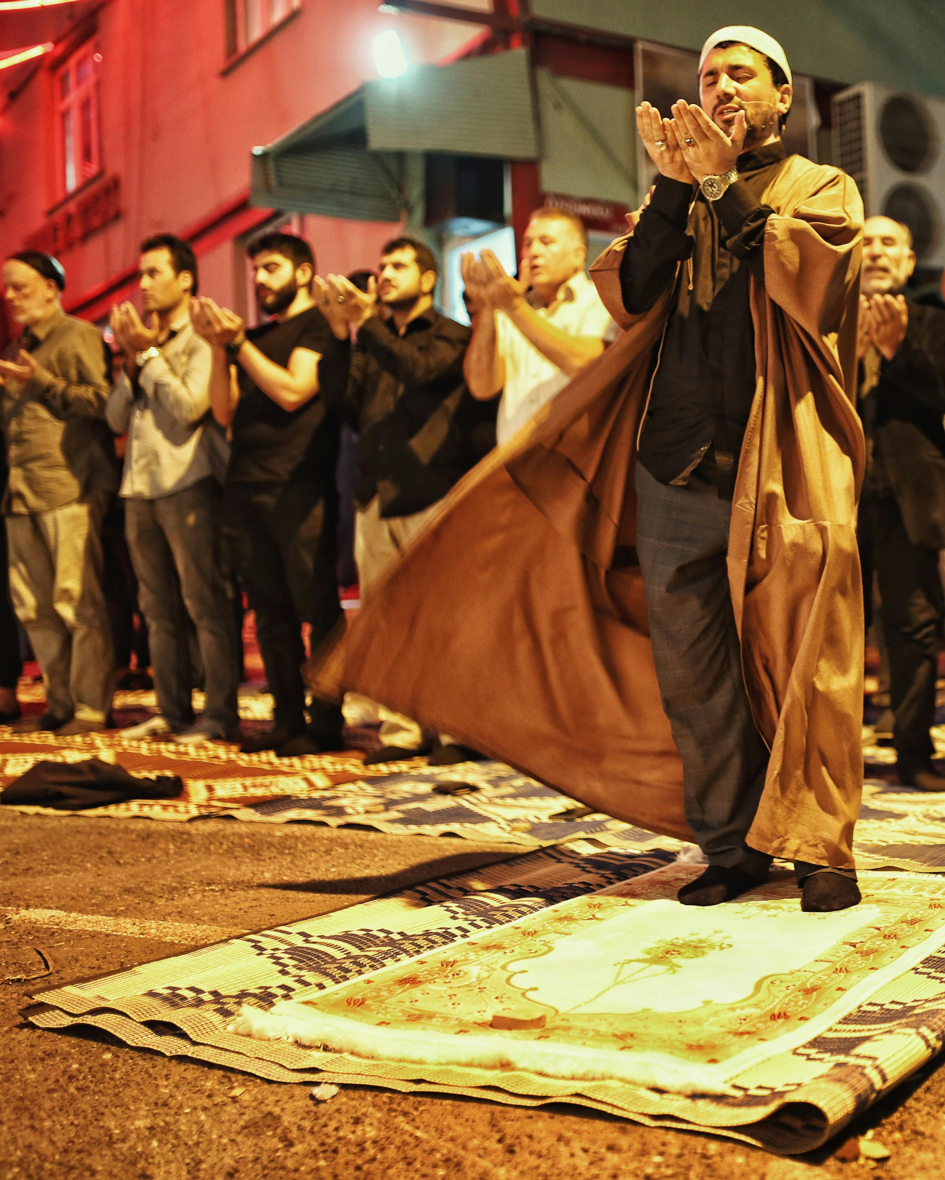 men standing with their hands together