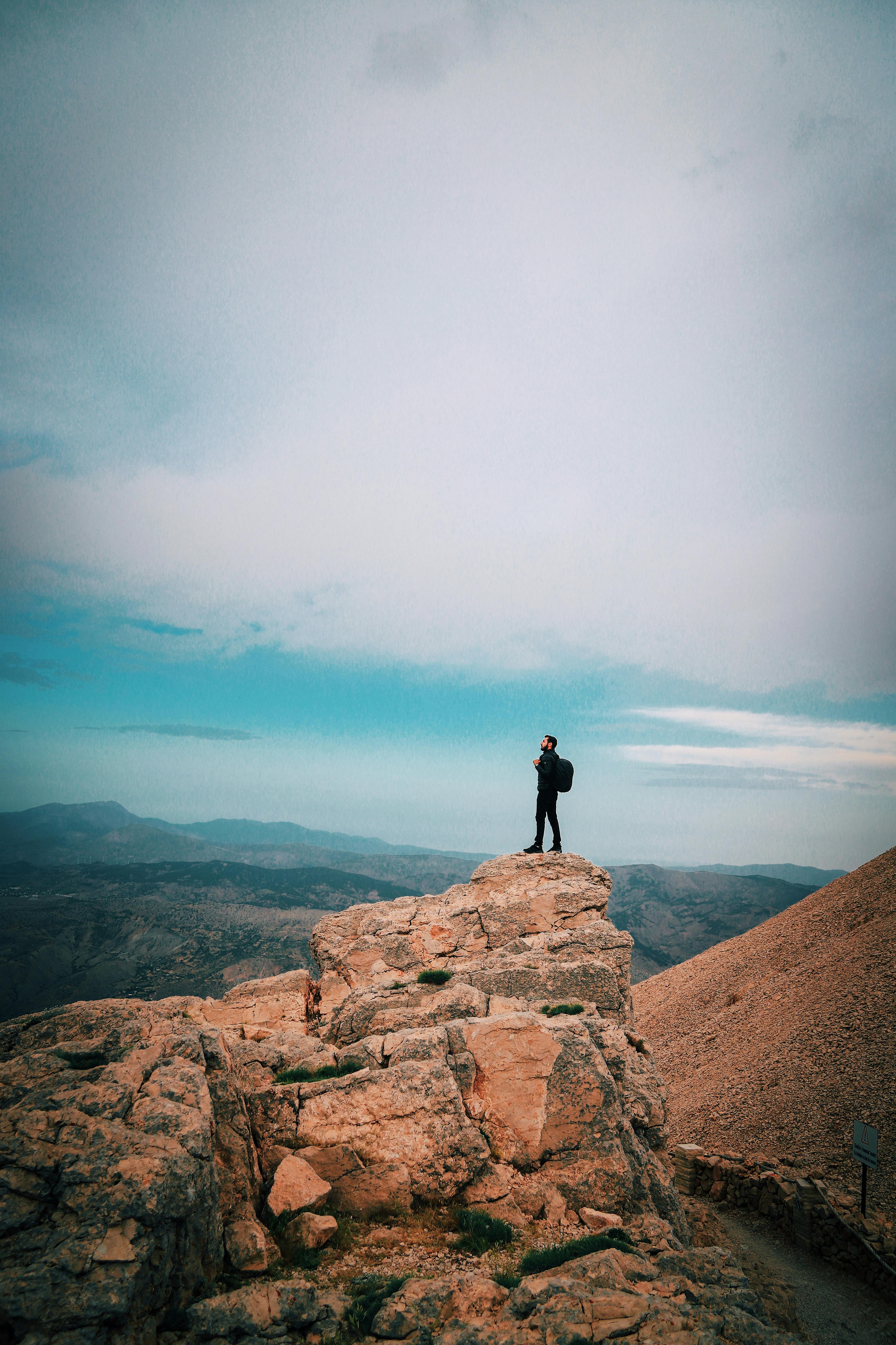 Person Standing on Big Rock Formation · Free Stock Photo