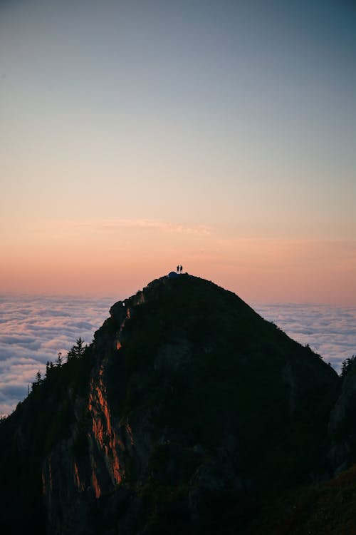Silhouette of People on top of the Mountain