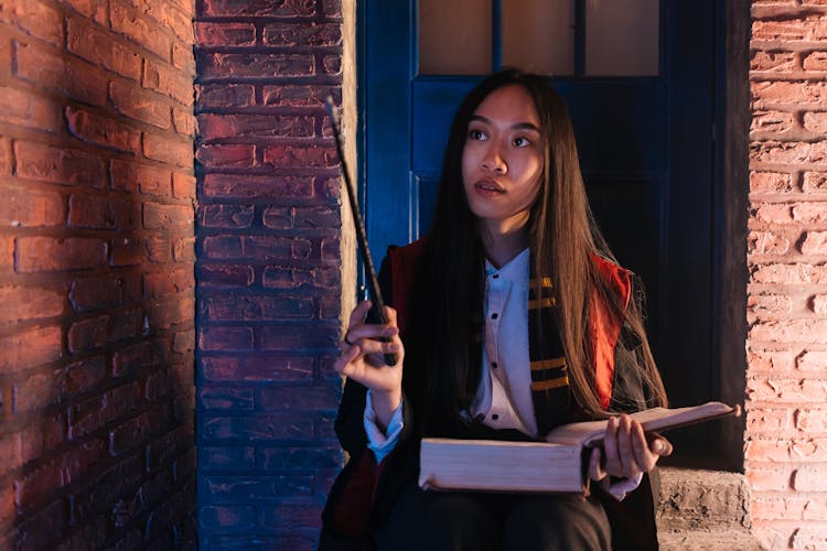 Long Hair Woman Holding A Book And Wand