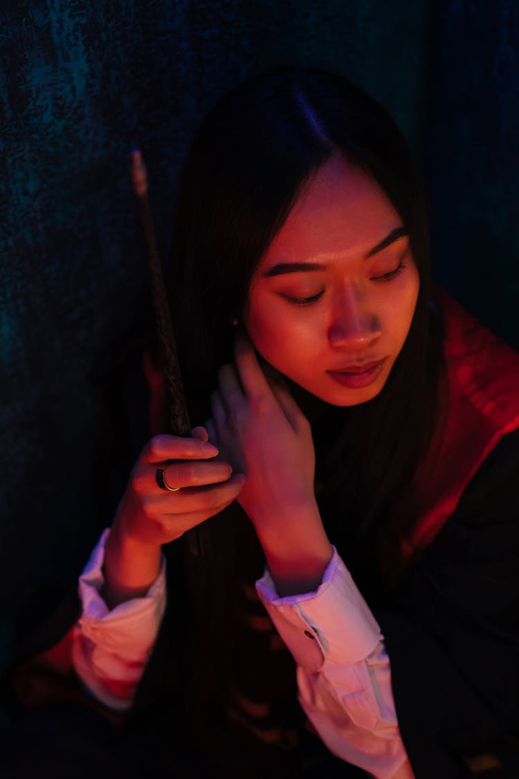 High Angle Shot Of Brunette Woman Holding A Wand