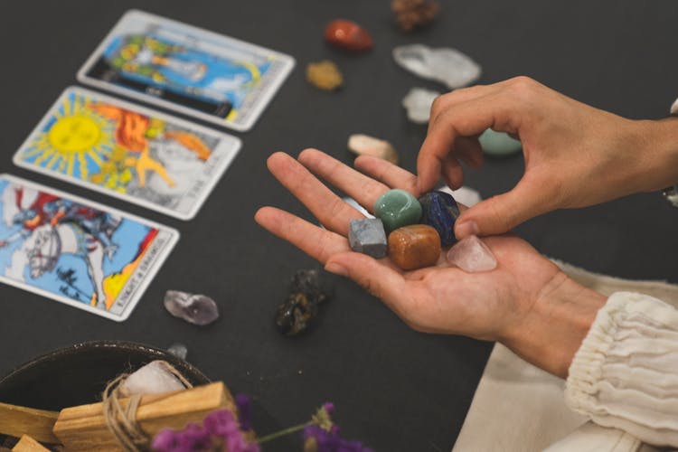 Person Holding Gemstones
