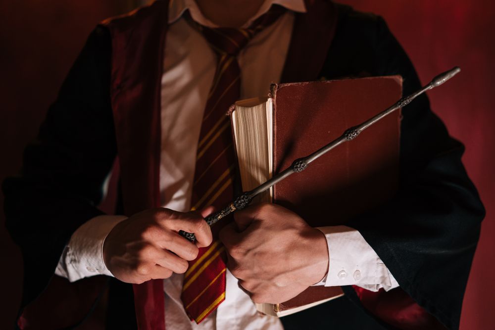 Close-up of a wand resting on a spell book