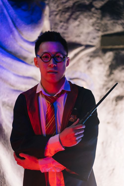 Free Man dressed as a wizard holding a wand, embodying magical fantasy theme. Stock Photo