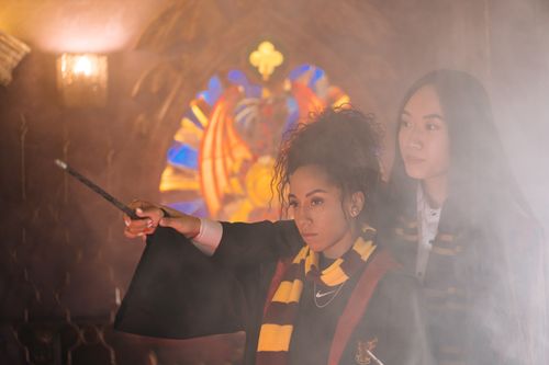 Free Two young women in wizard robes focus intensely during a magical lesson. Stock Photo