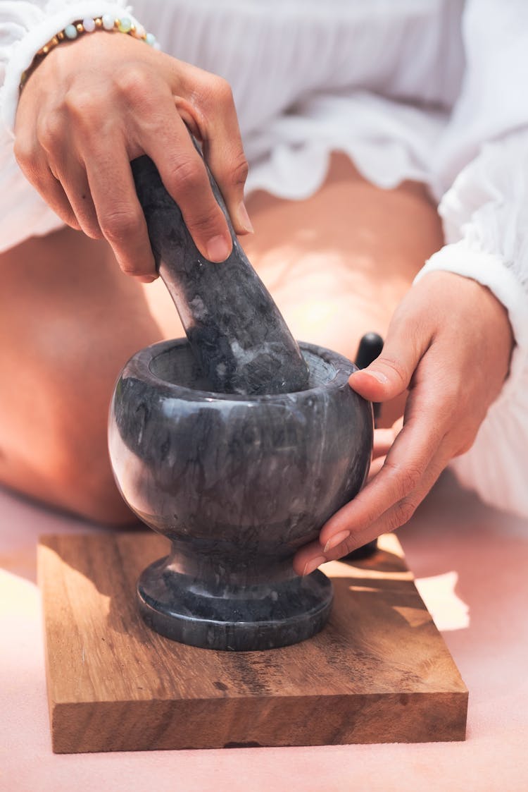 Person Using Mortar And Pestle 