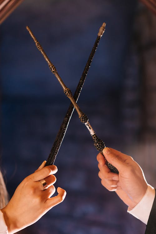 Free Two People Holding Magic Wands Stock Photo