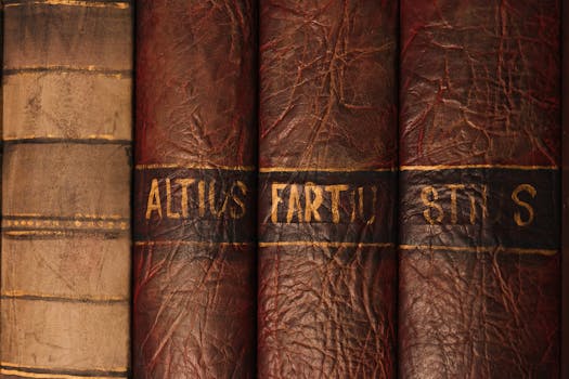 Detailed close-up of antique leather book bindings with ornate texture and golden text.