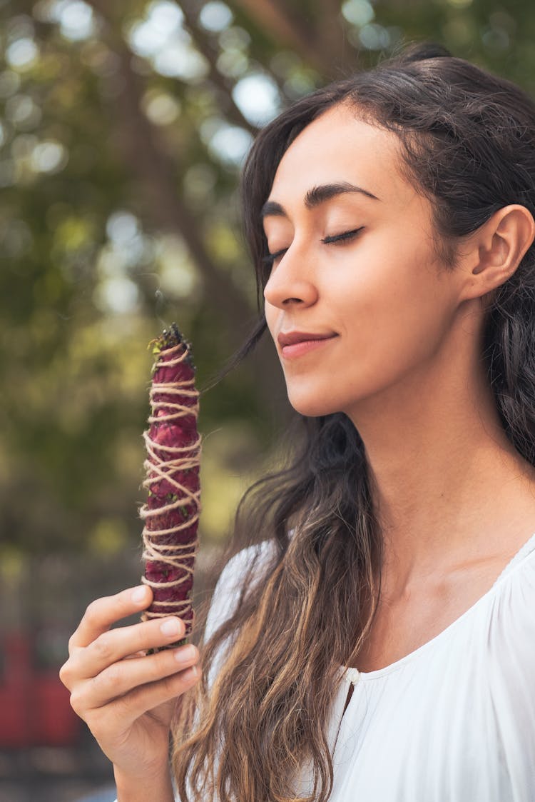 Woman Smelling Smoking Herbs