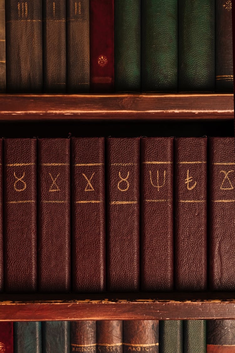 A Collection Of Books With Shaman Symbols On A Shelf