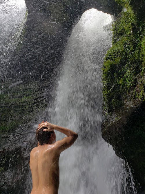 Man Showering Under  Waterfalls 
