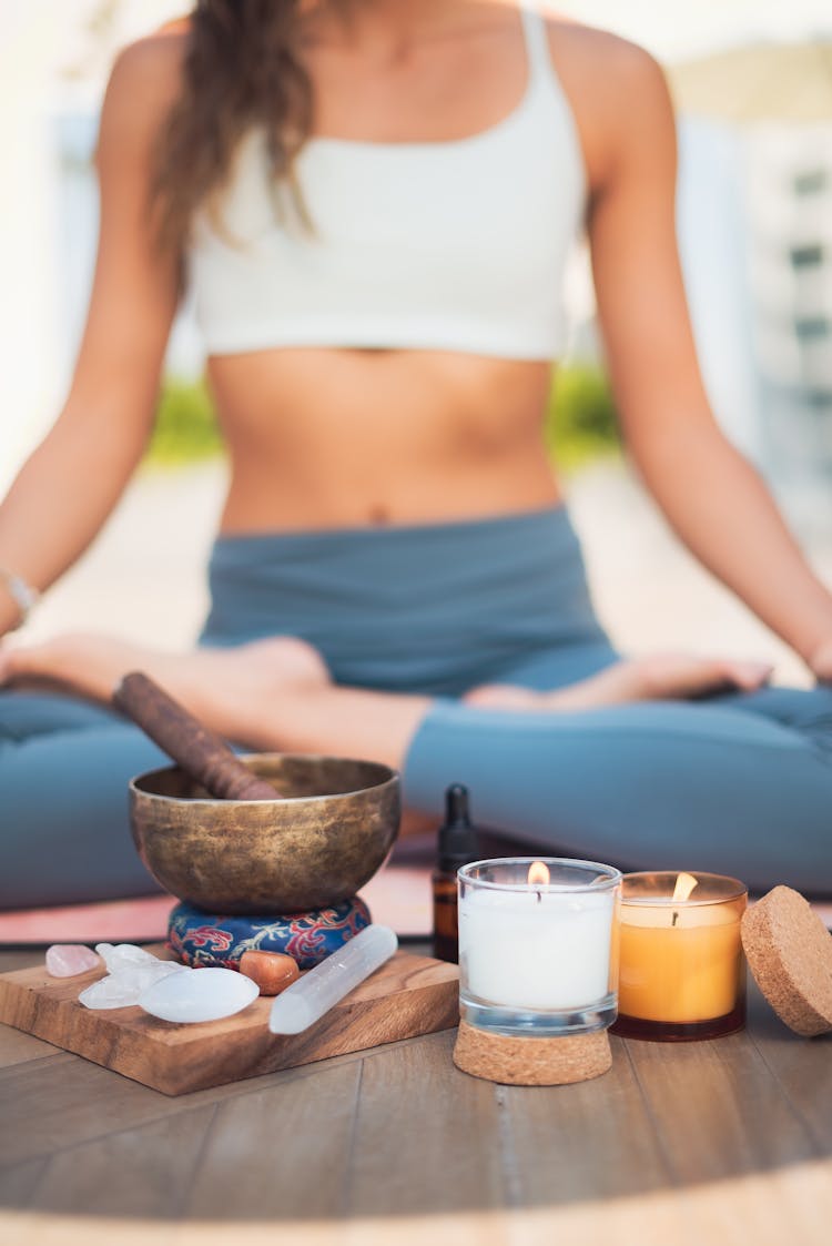 Woman Meditating By Candles And Incense