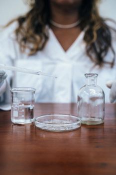 A female scientist in a laboratory conducting an experiment with lab glassware.