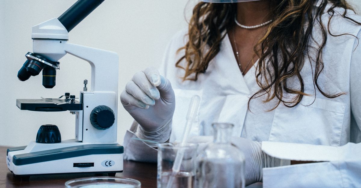 Microscopes and lab equipment set up at a community center in Ho, Ghana, with teenagers in lab coats