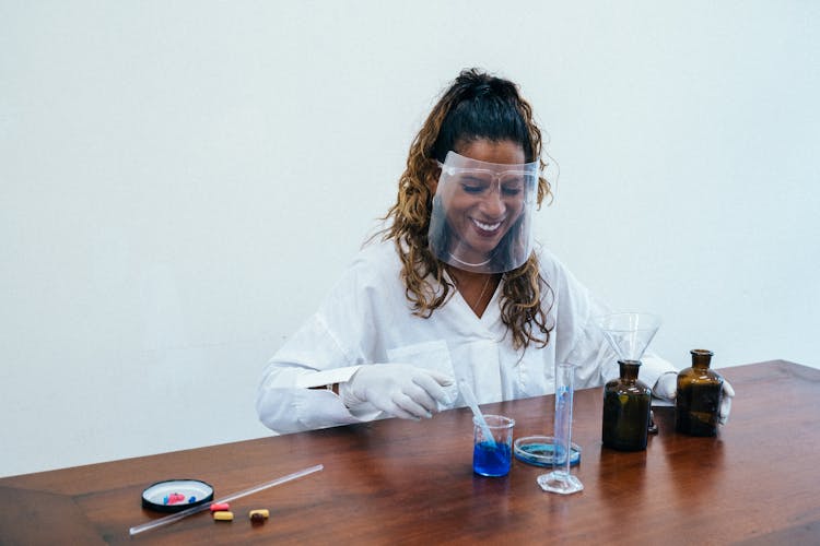 Woman Wearing Face Shield Doing Experiment