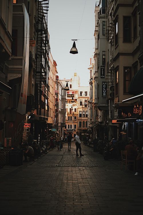Free Explore the moody charm of a bustling alleyway in Istanbul, capturing vibrant street life. Stock Photo