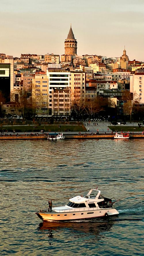 Free Majestic Galata Tower rises above Istanbul's lively waterfront, capturing the city's rich history and vibrant culture. Stock Photo