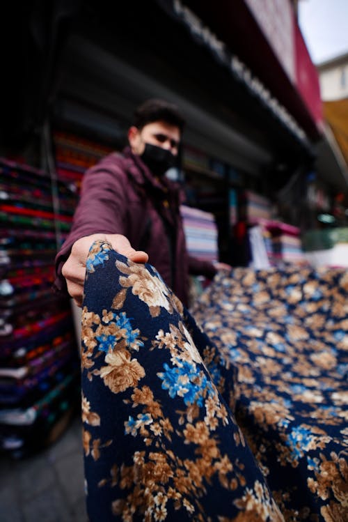 A Person Holding Textile with Floral Print