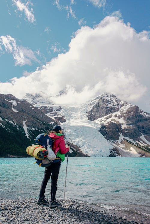 Hiker Standing by Mountain Lake