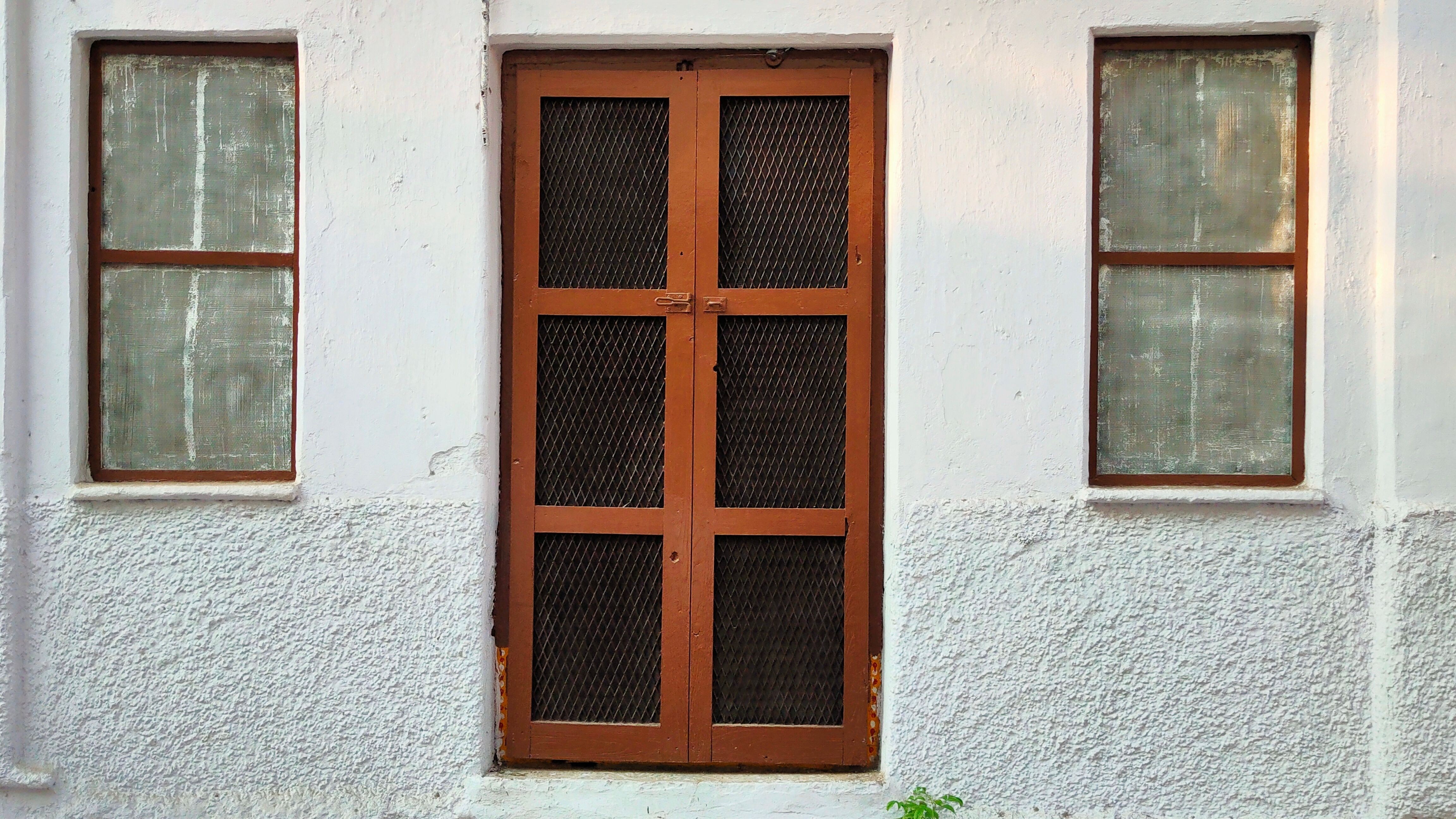 A wooden door and window frames set into a wall — a frequent termite entry point