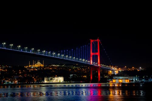Free Stunning night view of Istanbul's Bosphorus Bridge in vibrant lights over the water. Stock Photo