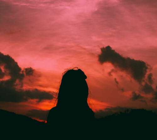 Free Silhouette of a Woman During Dawn Stock Photo