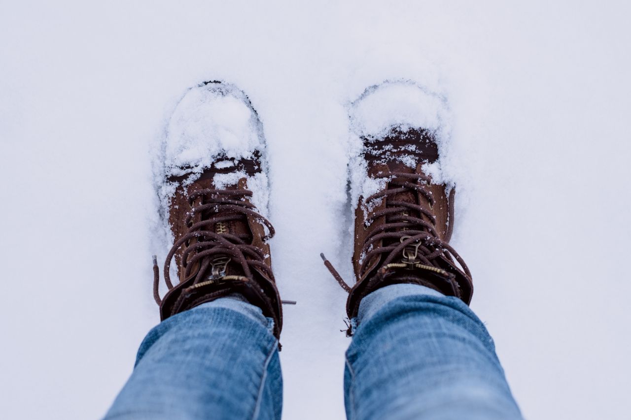 Snow-covered winter boots in fresh snow
