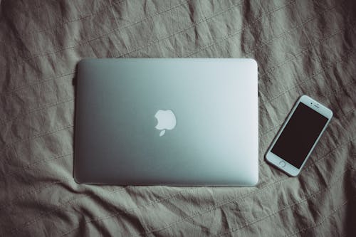 Silver Macbook Beside Silver Iphone 6