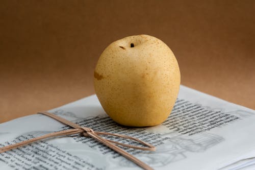 Free Close-Up Photo of Pear Fruit on top of Paper Stock Photo