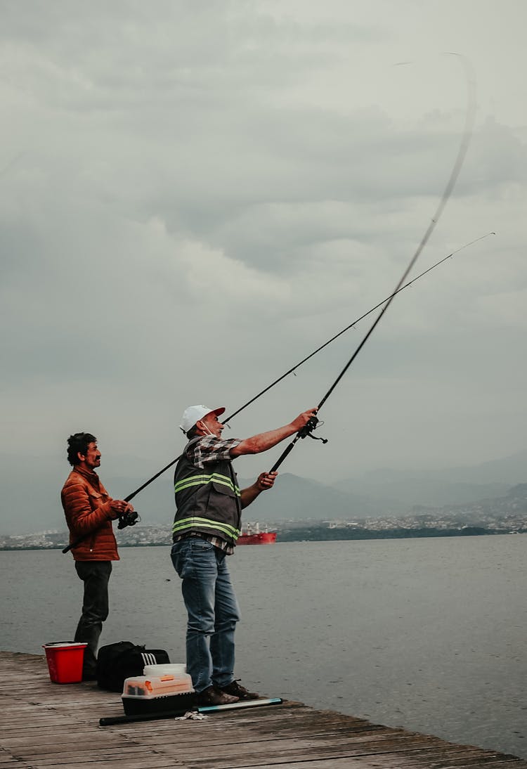 Men Holding Fishing Rods