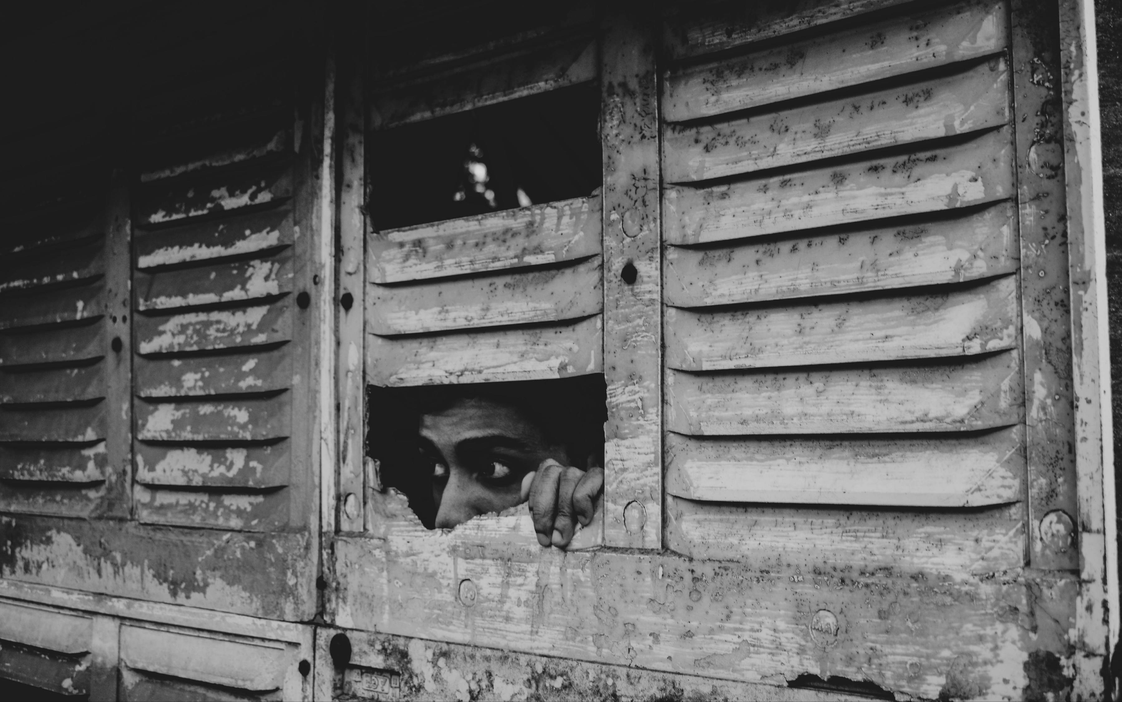 Grayscale Photo of Man in Wooden Door · Free Stock Photo