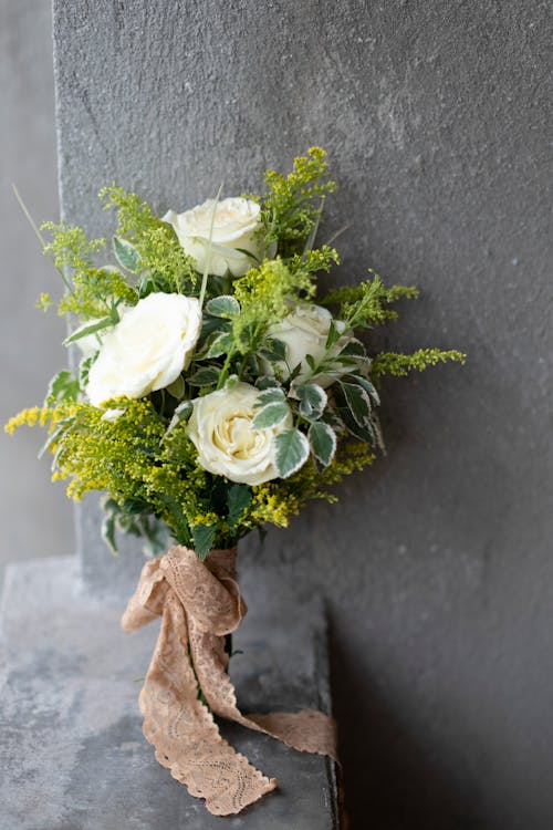 White Rose Bouquet on Brown Concrete