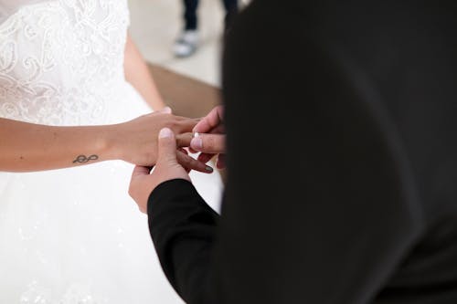 A Man Putting on a Ring to the Woman's Hand