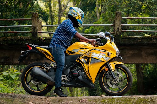 Man Riding a Yellow Motorcycle