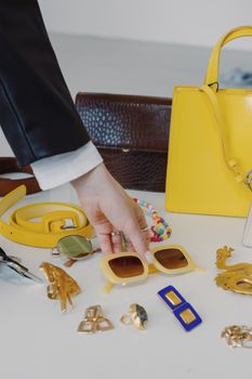 Sophisticated layout of fashion accessories including handbags and sunglasses on a table.