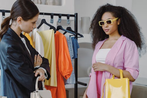 Woman in Pink and White Top Wearing Yellow Framed Sunglasses