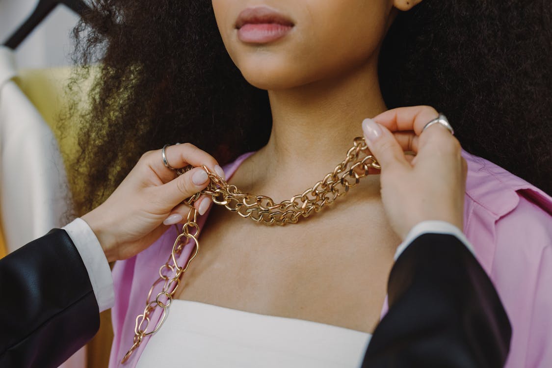 Free Person in Black Blazer Holding Gold Necklace Stock Photo