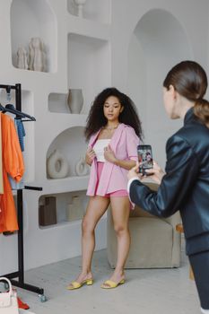 Young model poses in stylish outfit during indoor fashion photoshoot.