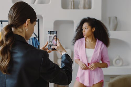 A Woman Taking Photo of a Female Model
