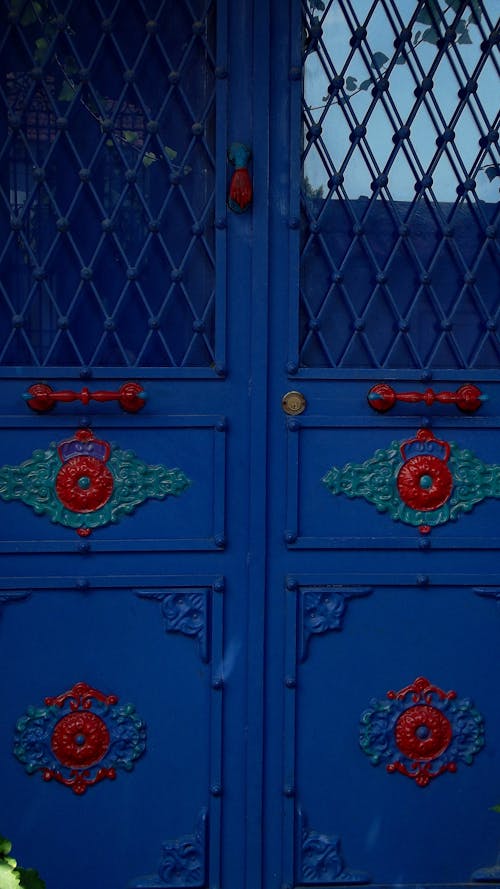 Bright blue gates with ornamental doors