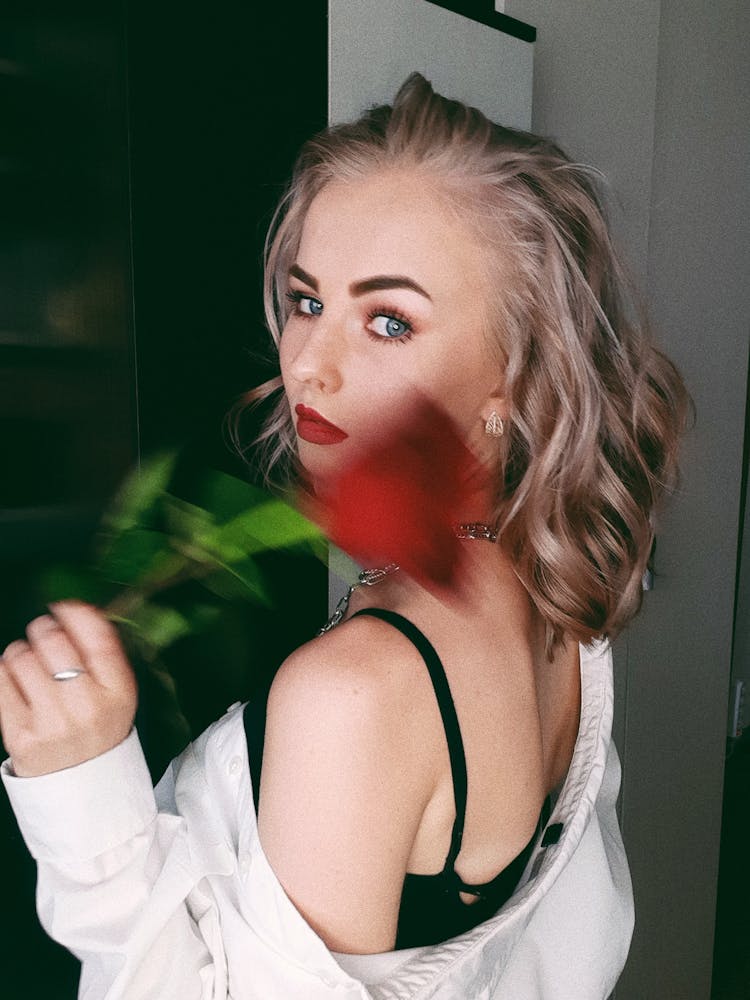 A Woman Holding A Flower Showing Her Undergarment