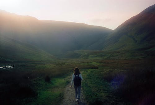 Free A Woman Walking on the Hiking Trail Near the Mountain Stock Photo