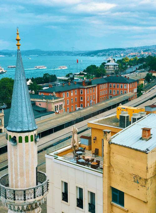 Free A beautiful view of Istanbul's coastline, featuring a prominent minaret and vibrant cityscape. Stock Photo