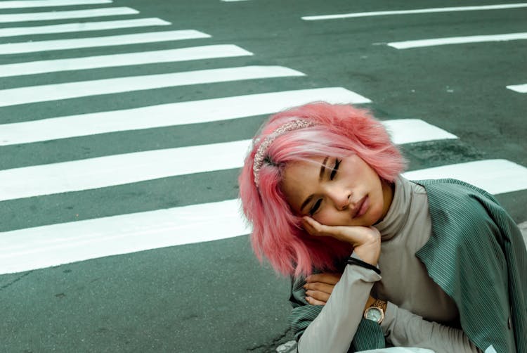 Portrait Of Woman With Pink Hair Leaning Her Face On Hand