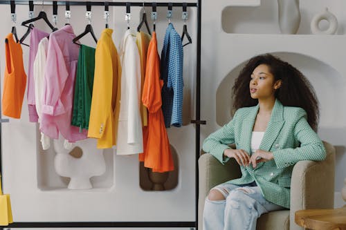 Free Woman in Green and White Checkered Blazer Sitting on Sofa Chair Stock Photo